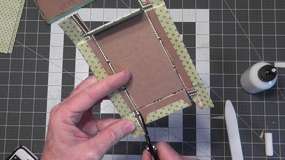 Cut along each end of the short chipboard, then make an angle cut as shown.  Also glue down the edges onto the chipboard as shown to have a finished edge.