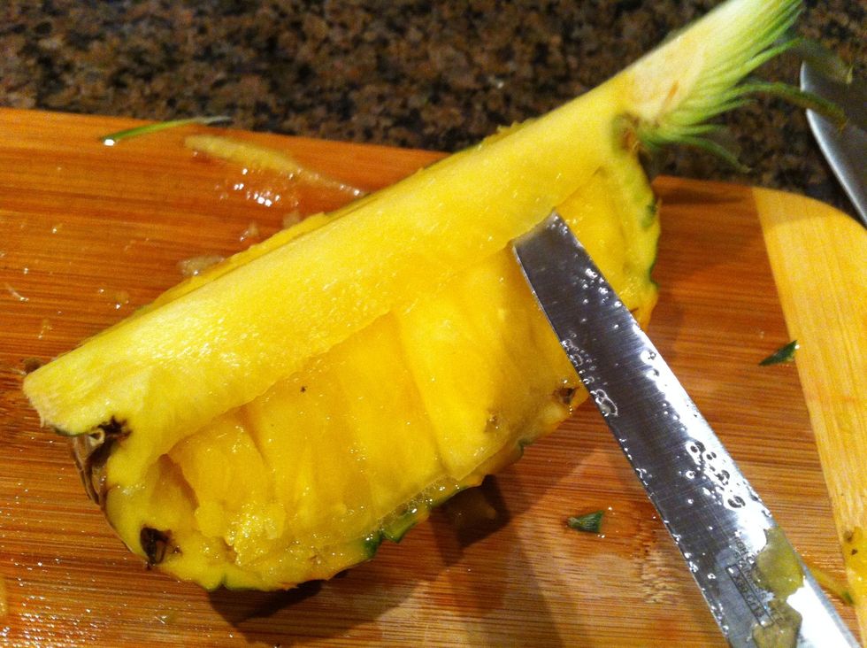 Cut along the core and around the base to loosen the flesh