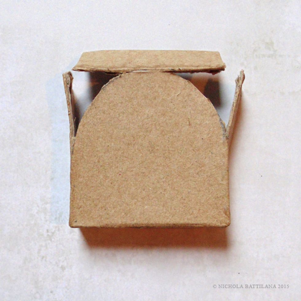 Cut along the curved line as shown, keeping the edges attached as shown.