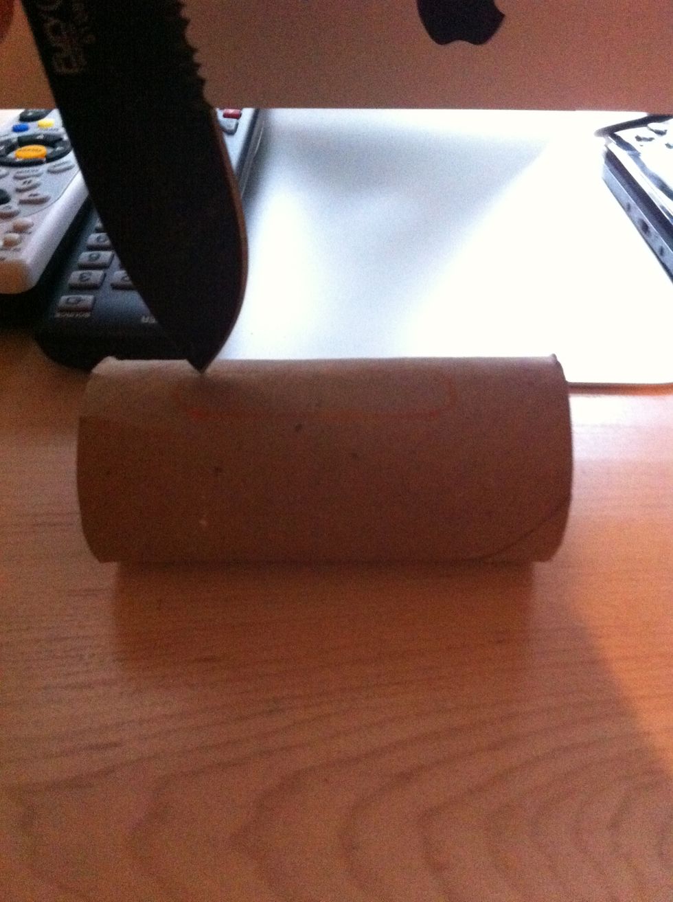 Cut along the line that you made. Be careful not to hurt yourself or to bend the roll too much.