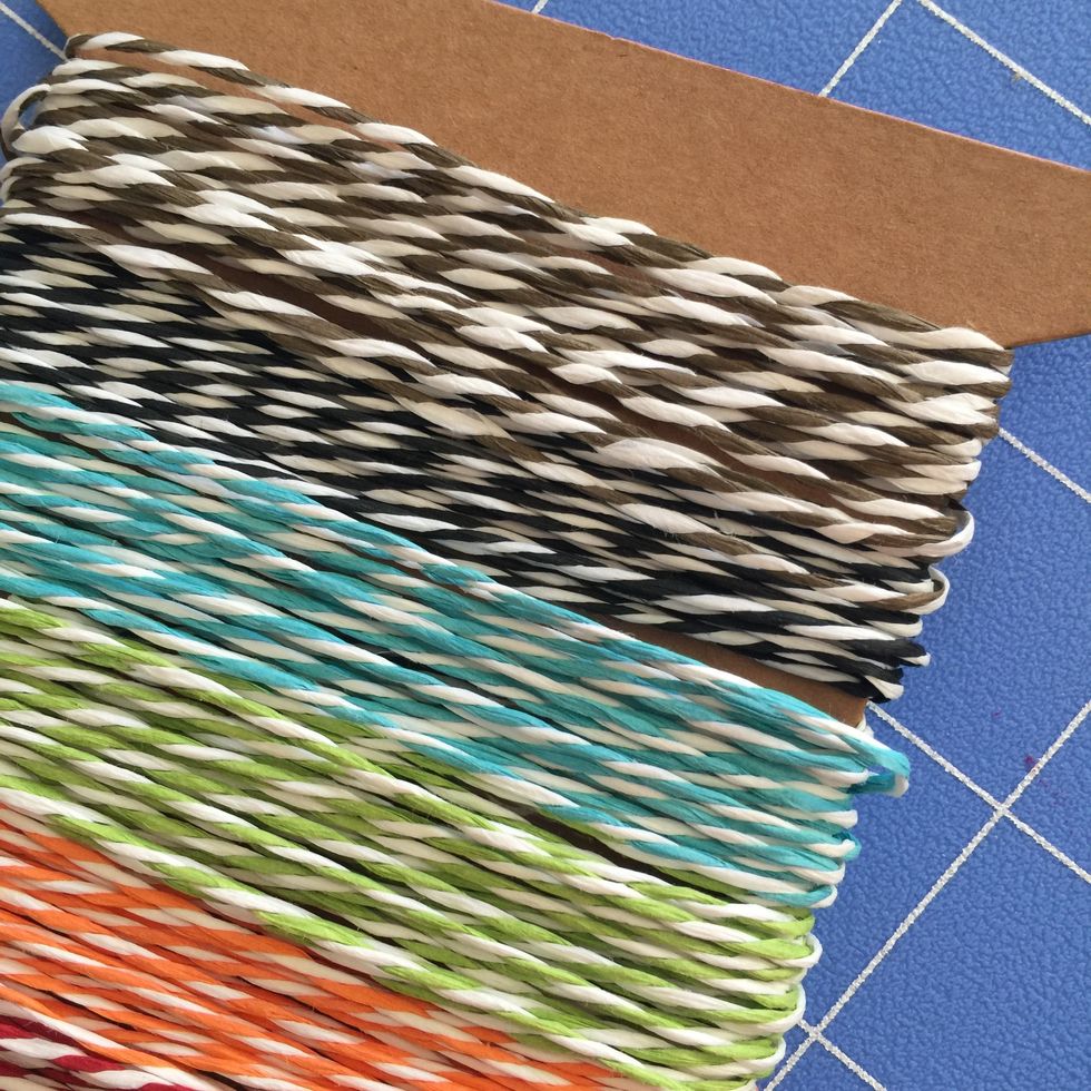 Cut an 18 " length of baker's twine in Grey/white or Black/white and run through the two layers of paper on card front.