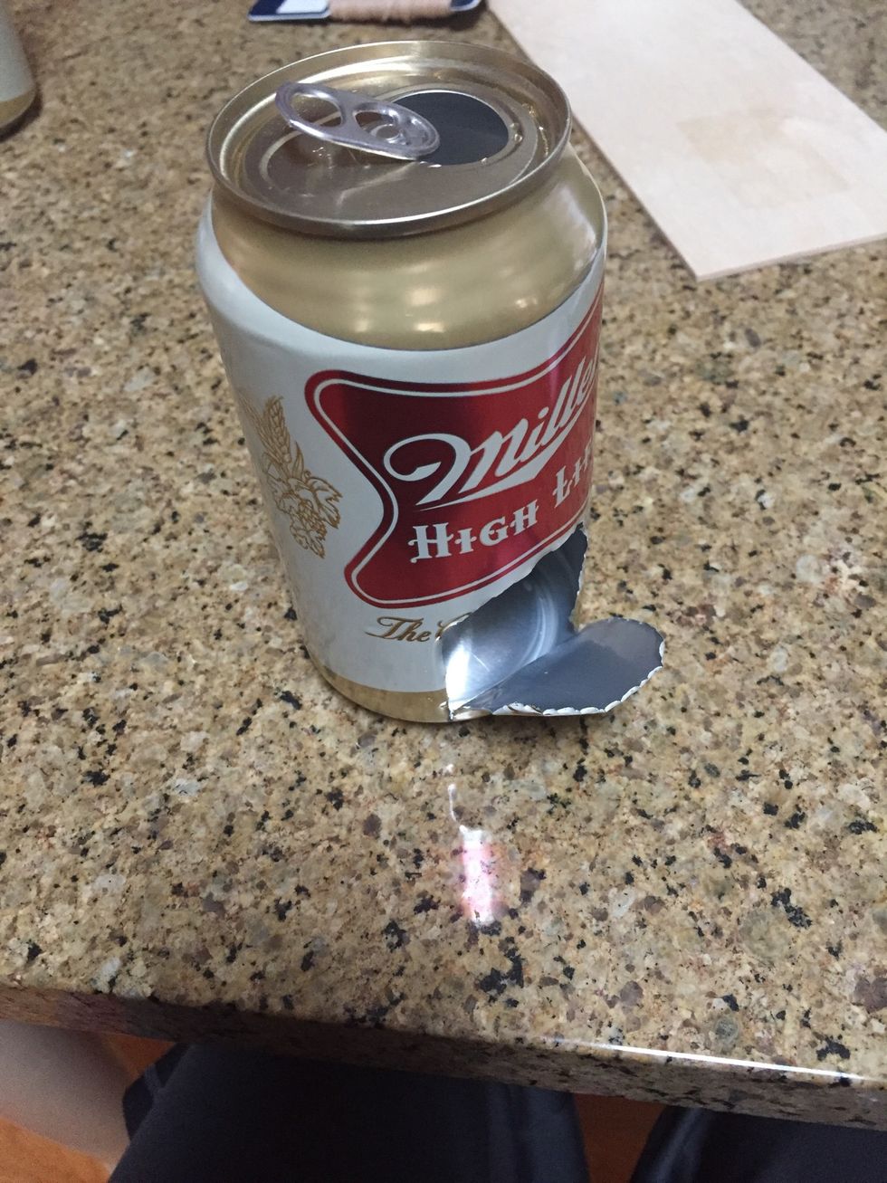 Cut an opening in the front of the first can