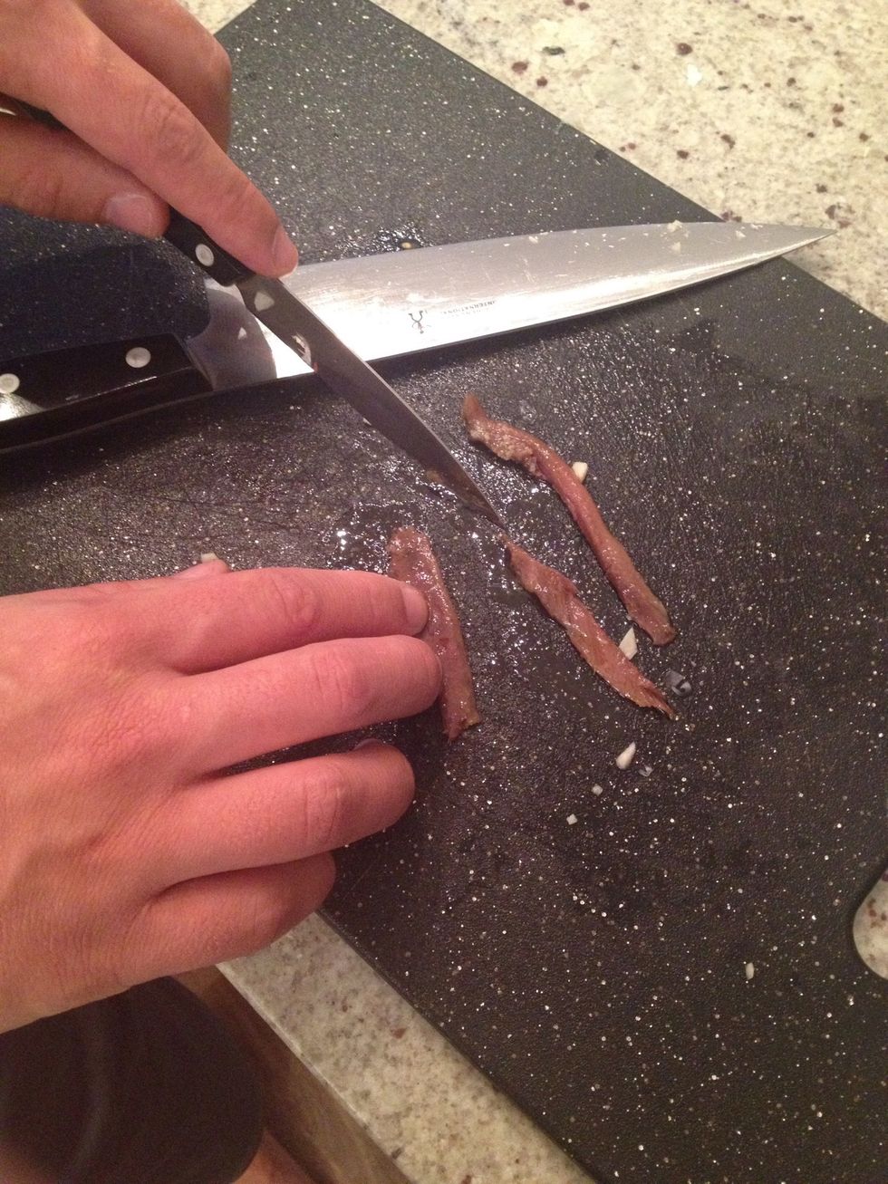 Cut anchovies and add to onions. Do not add too many anchovies otherwise they overpower the dish