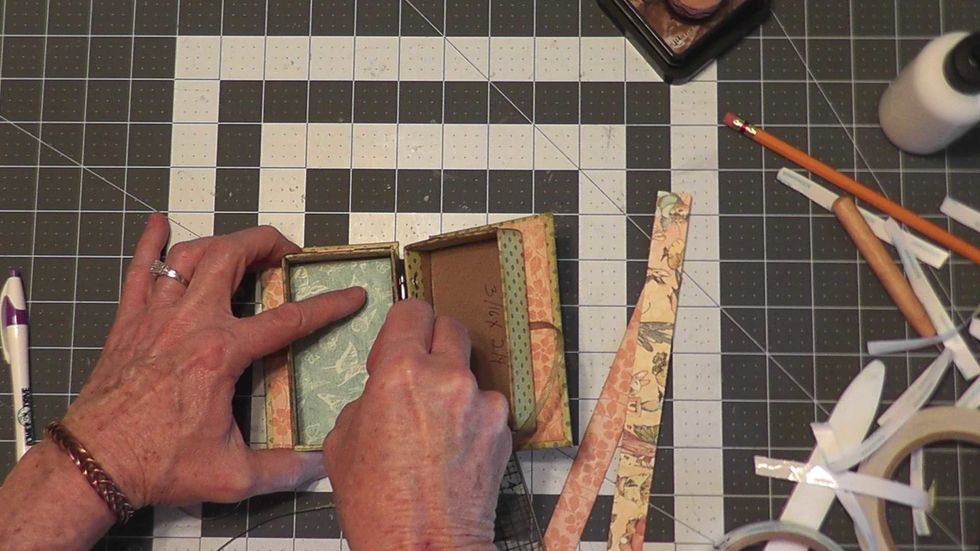 Cut and ink 2 pieces of patterned paper 3 7/8" tall x 2 1/4" wide for the inside of the boxes.  Glue one into the left side only.  Set the other piece aside until you attach the fold out album pages.