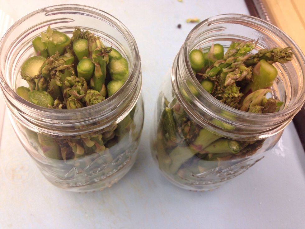 Cut and trim asparagus to fit into each jar. Make sure to pack each jar fairly tight.