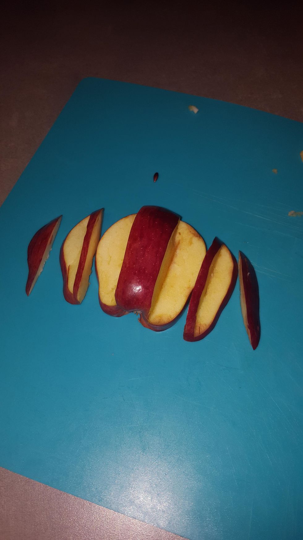 Cut another half of the apple on the same side