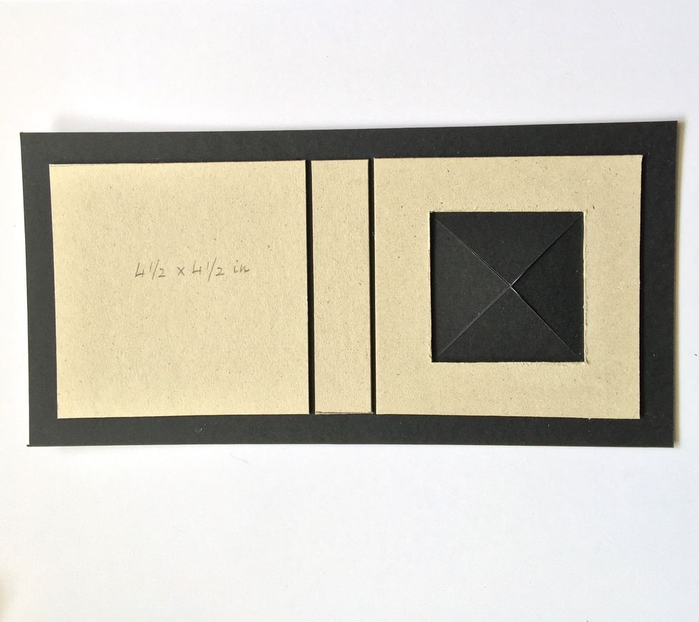 Cut another piece of cardboard to make the spine. Glue the three pieces on a black cardstock. Live a space free between them, at least as thick as the cardboard. Cut inside the window as shown.