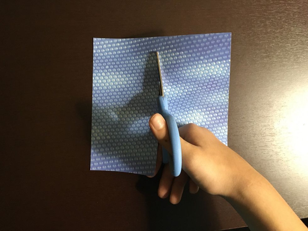 Cut another piece of paper in half