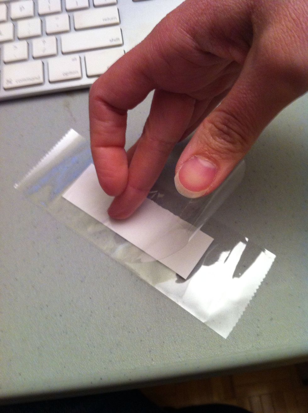 Cut another piece of tape and lay down on the back in the same way, pressing the tape down a line in the centre and smoothing outward. Applying it in this way will reduce...