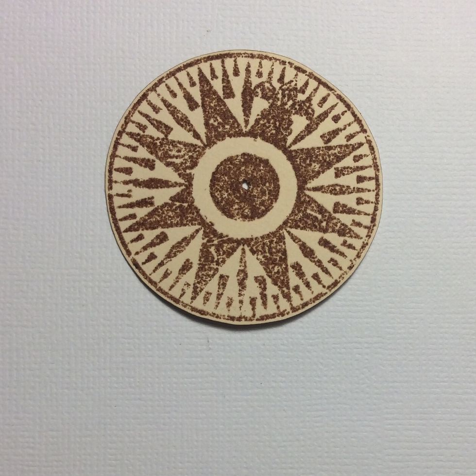 Cut around stamped compass image leaving a small border. Make a hole in the centre.