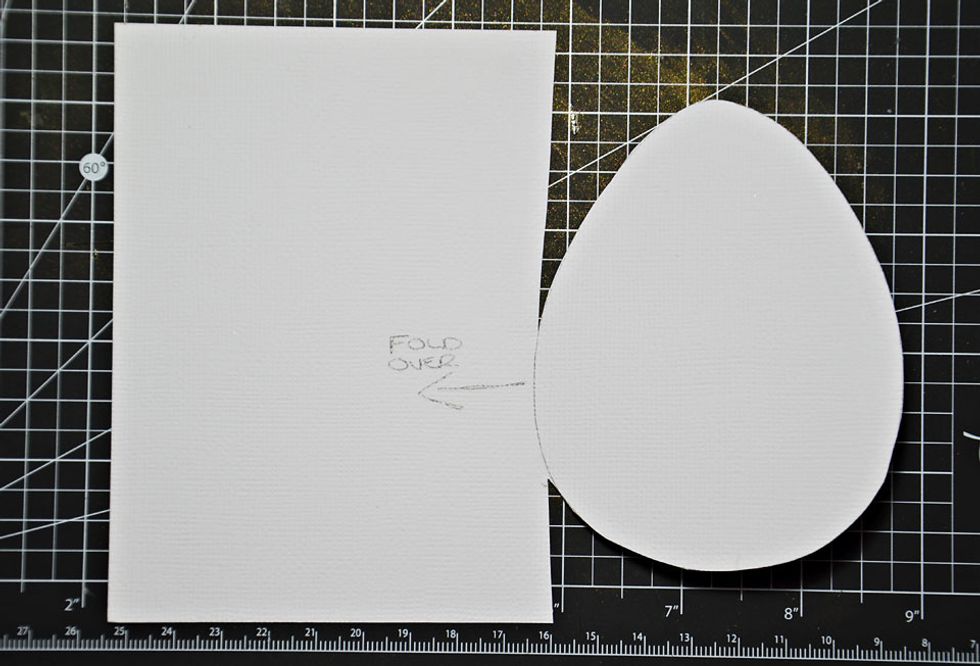 Cut around the egg shape leaving and small piece uncut for a fold line. Fold the egg shape over and then cut around the other egg shape.