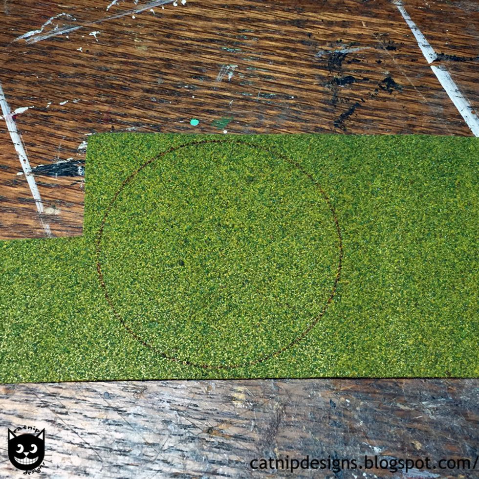 Cut around the inside of the circle to remove the pen line and create the right size grass patch.