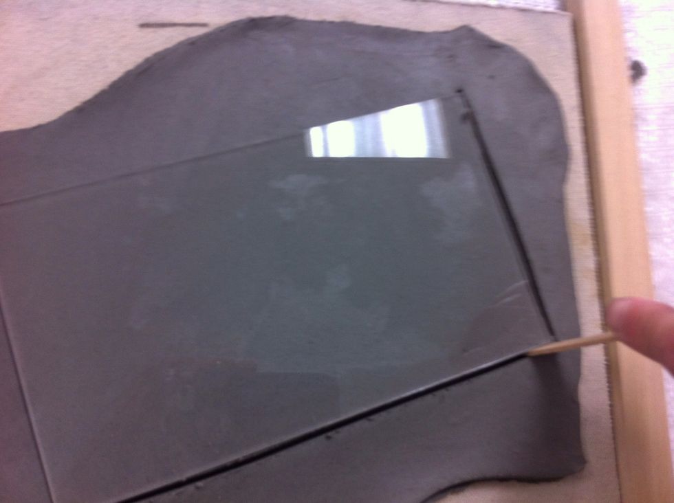 Cut around the template. I used a Popsicle stick. I have clay tools, but I don't want to get my air dry clay tools and my firing clay tools mixed up! I use disposable tools for the air dry clay!
