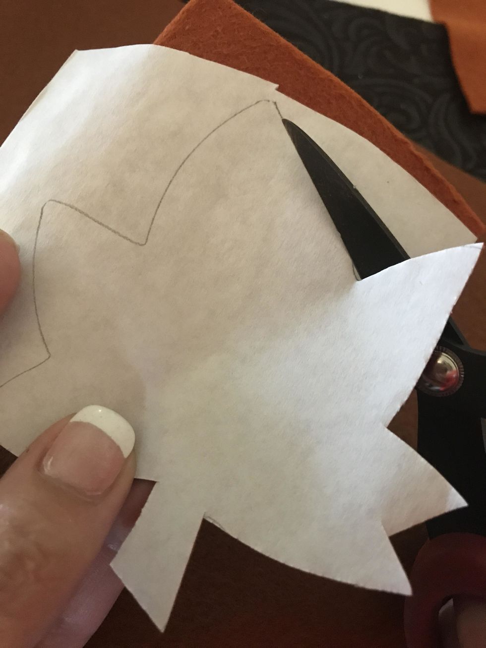 Cut around your pattern using scissors. I find that small scissors are helpful at maneuvering around designs and sharp tips help give a clean cut.