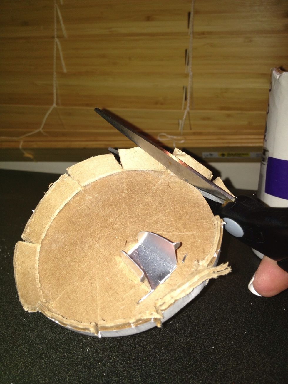 Cut as close to the edge as possible, it will ensure a better fit. If you don't get it just right you can hot glue it into the jar ring, but it's not necessary.