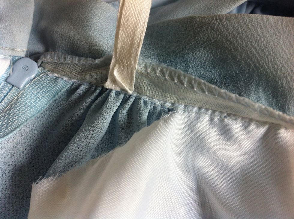 Cut as close to the seam as possible without cutting stitch lines. Cut all around until the slip comes off.