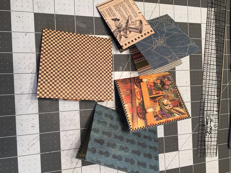 Cut assorted sizes of the patterned paper and fold into signatures.  You will want a few of them to be the same size as the black and purple page signatures.