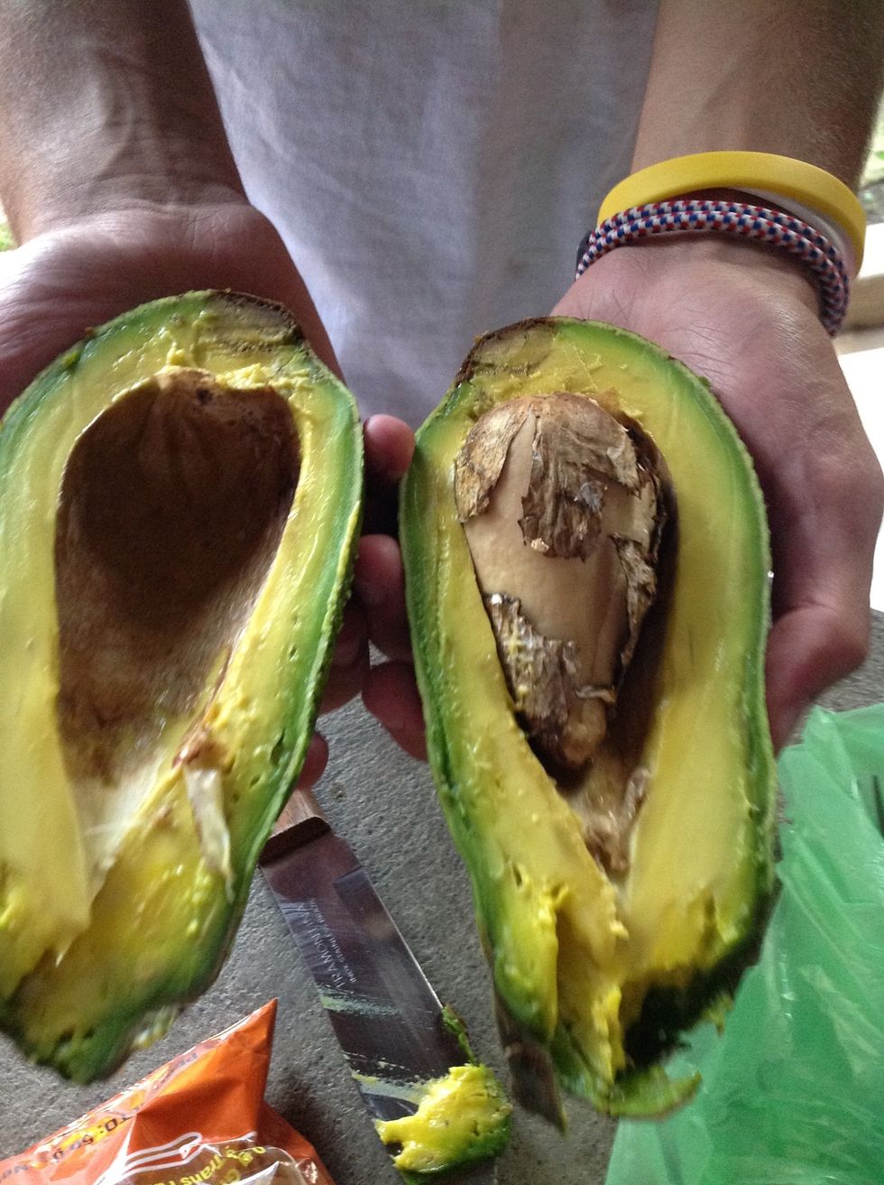 Cut avacado in half and remove the pit.