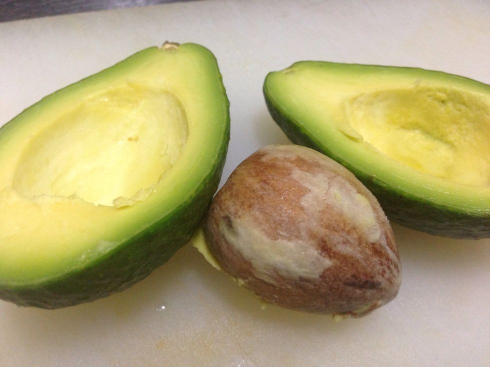 Cut avocado in half, scoop seed out
