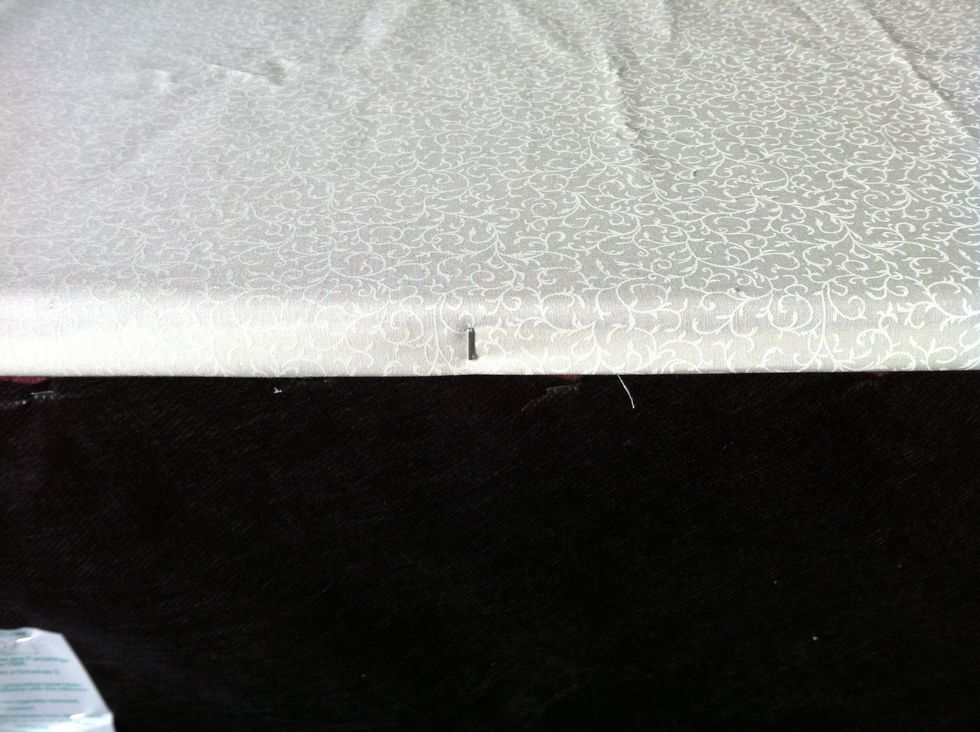 Cut away excess fabric from base of ottoman