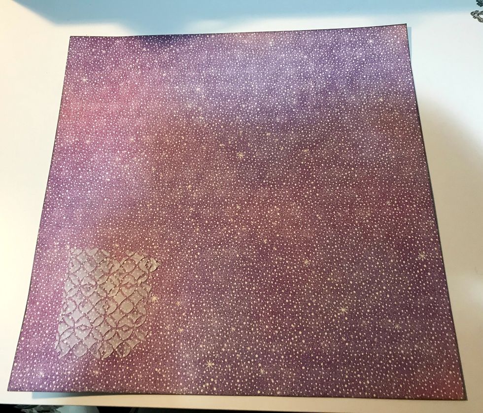 Cut barcode off of toadstool paper. Ink edges of paper with Photogenic Ink & a blending tool. Place lattice stencil in bottom left corner & use a palette knife to spread paste overtop of the stencil.