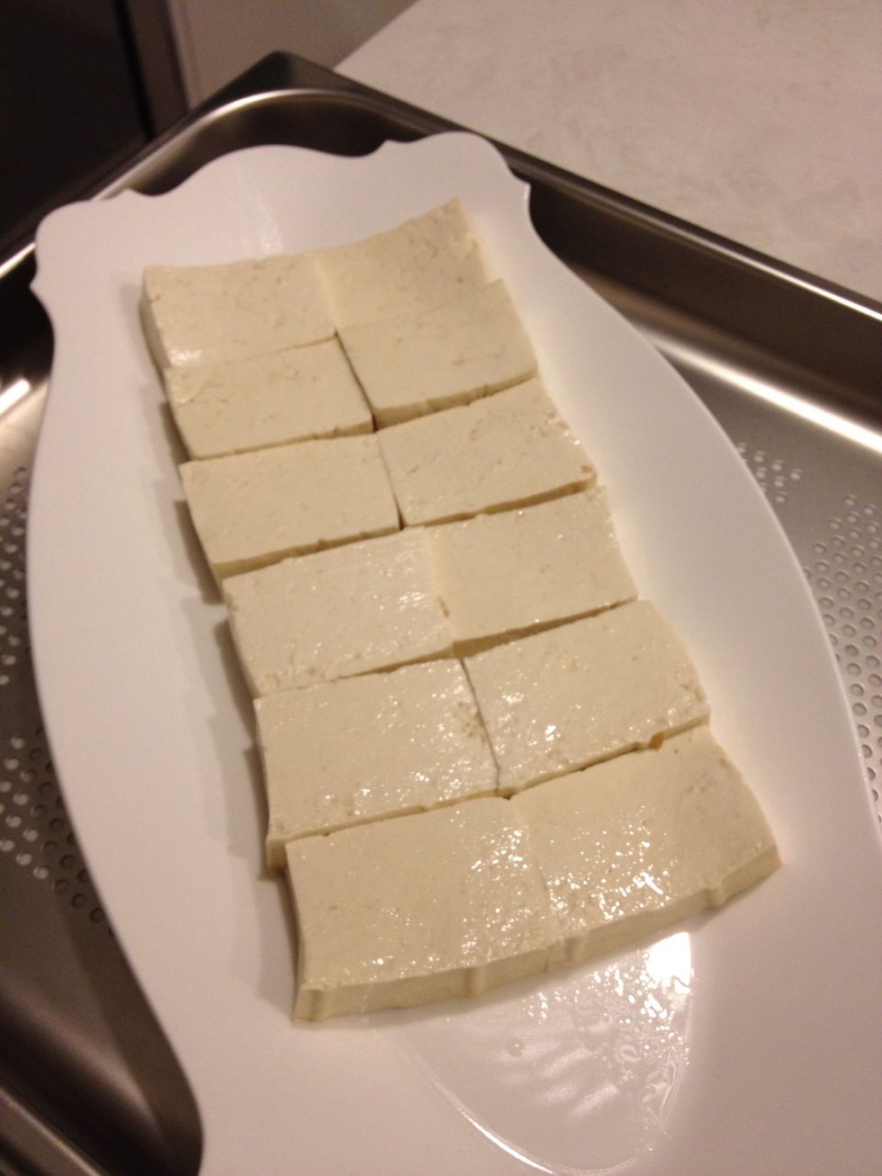 Cut bean curd (tofu) to approximately half an inch thick.