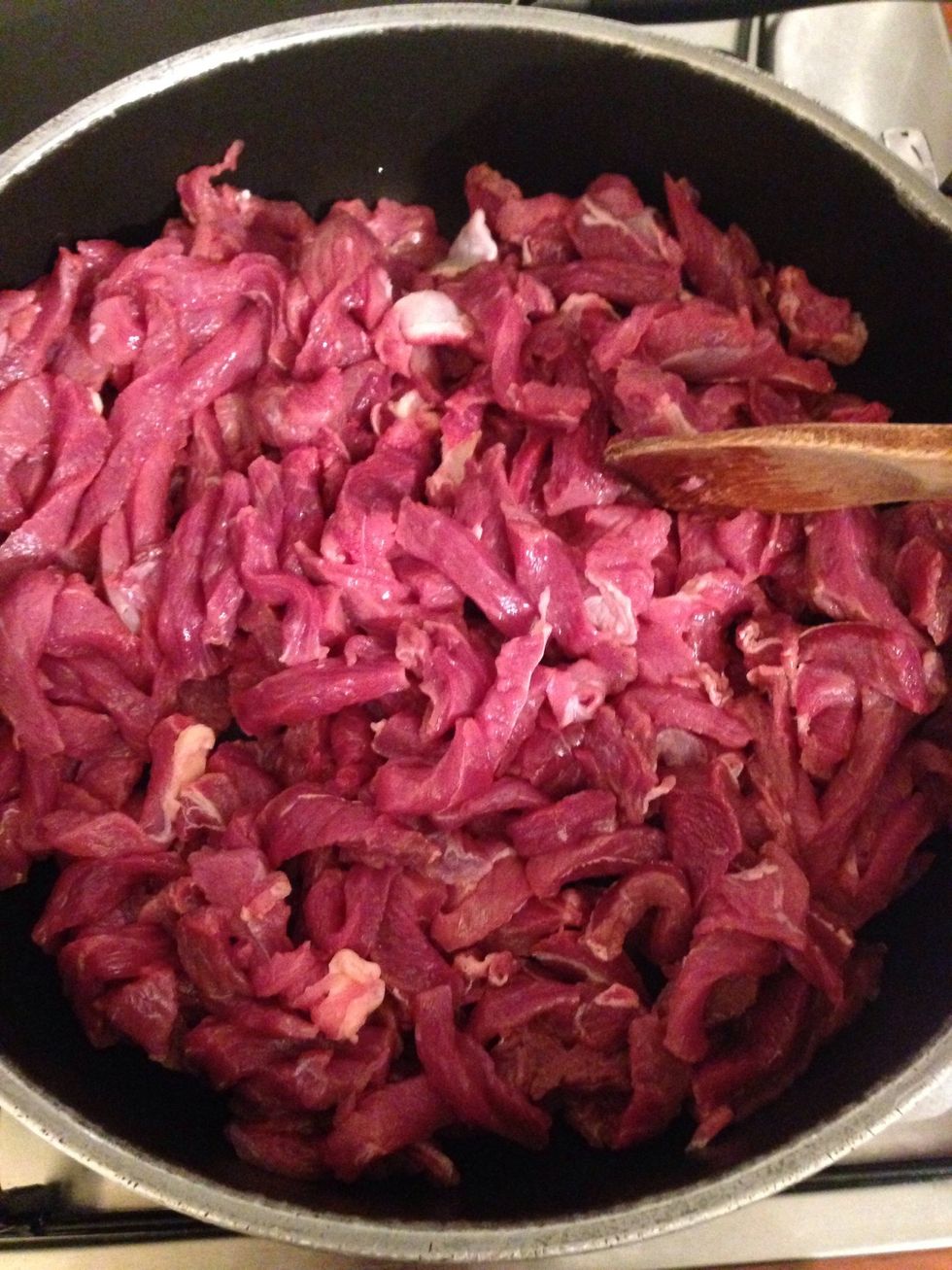 Cut beef into long and thin slices, pit into the hot pan, ad half a cup of hot water and let it get cooked
