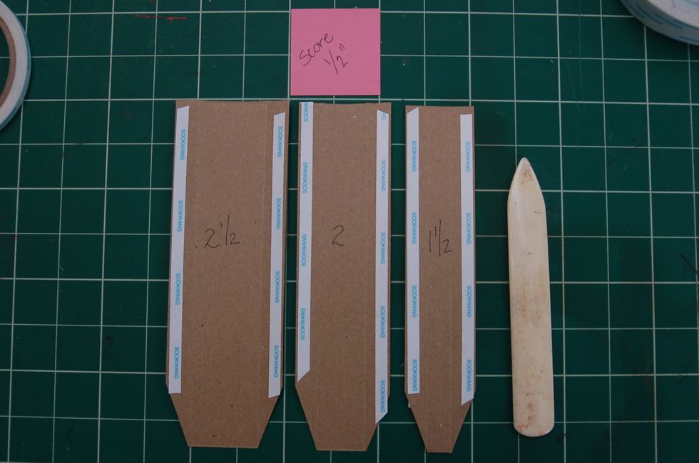 Cut binding from file folders or light weight chipboard. The measure's listed above may vary depending on the size of your book. This book is 1 1/2 and two 1 inch pieces.