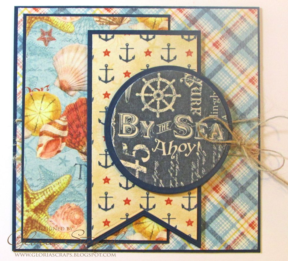 Cut blue cardstock to 3 x 4 5/8 inches. Cut Beachcomber paper to 2 7/8 x 4 1/2 inches. Attach the Beachcomber paper to the blue cardstock and attach the panel to the left side of the card front.