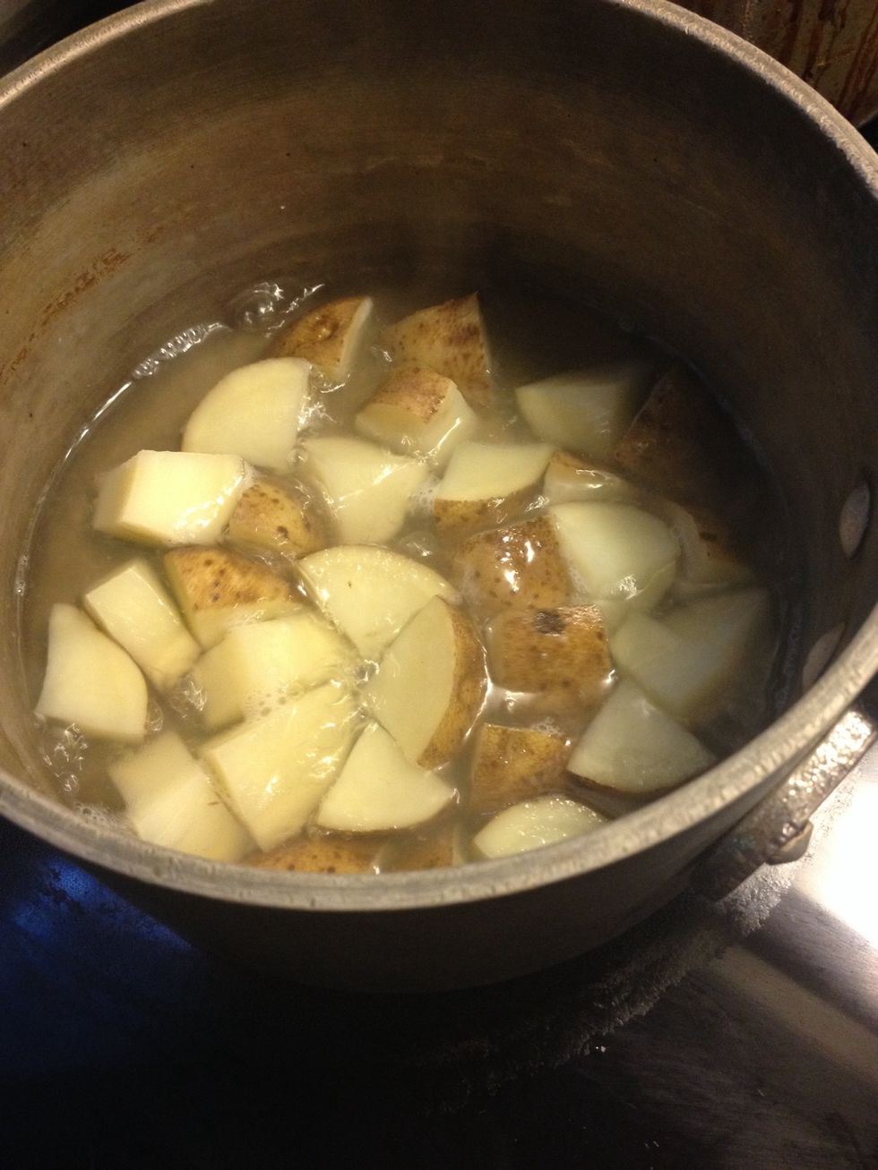 Cut & boil your potatoes with garlic salt