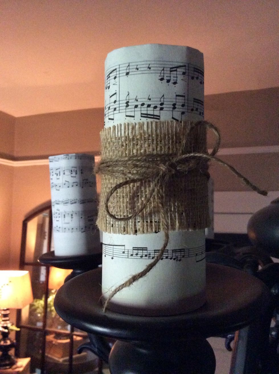 Cut burlap strips, then wrap and tie around paper rolls with jute.