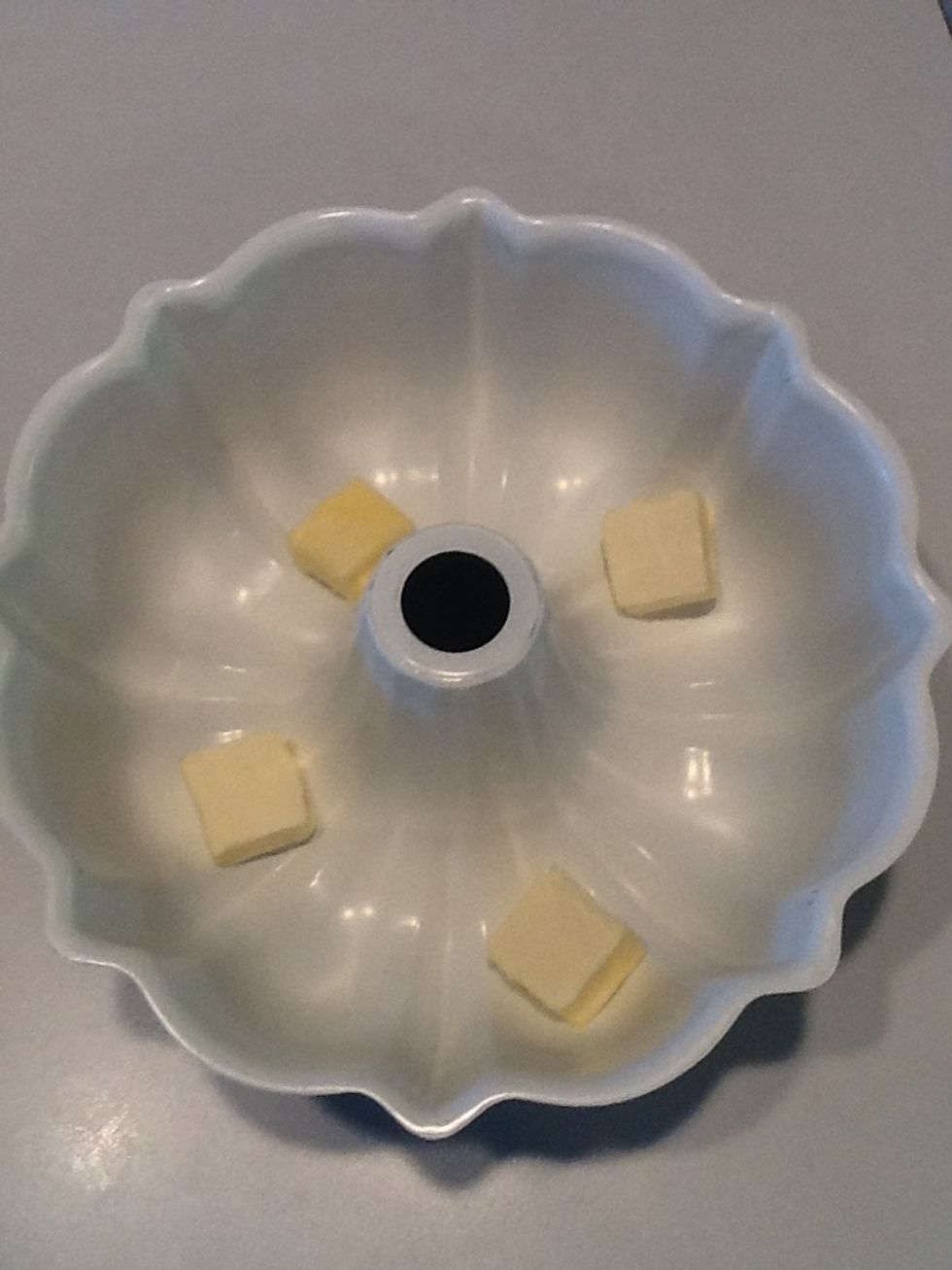 Cut butter in pieces and place in a bundt pan.