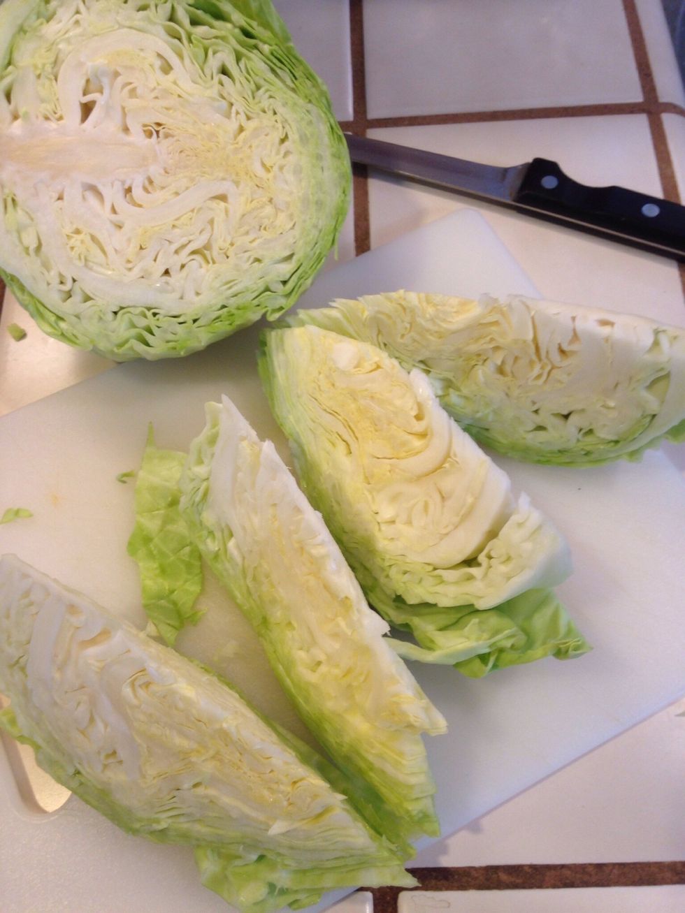 Cut cabbage into wedges. Put each wedge in a large squares of tin foil.