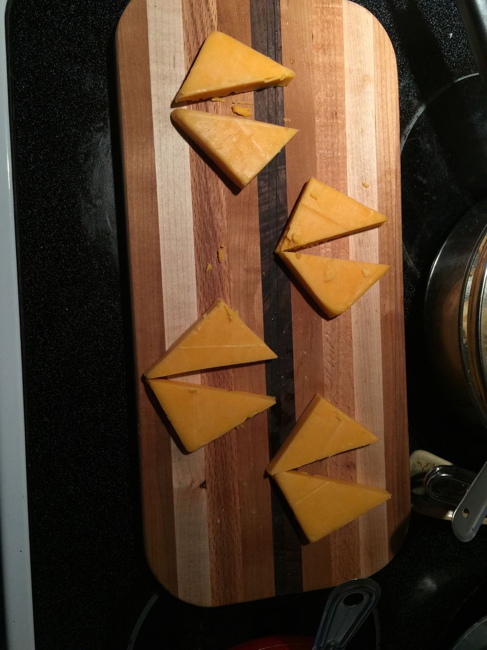 Cut cheese into squares and then triangles