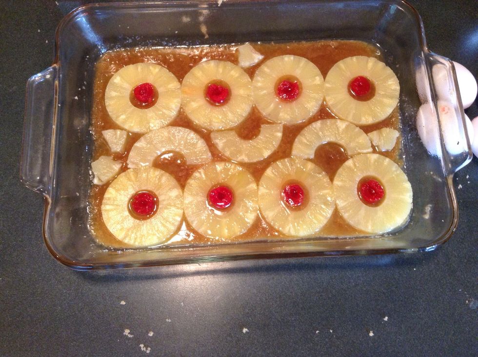 Cut cherries in half and place them in the center of each pineapple