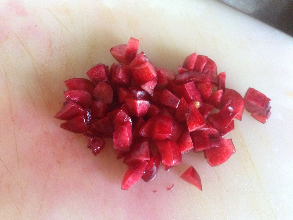 Cut cherries in half. Then cut half cherry in half again remove seed and dice up.