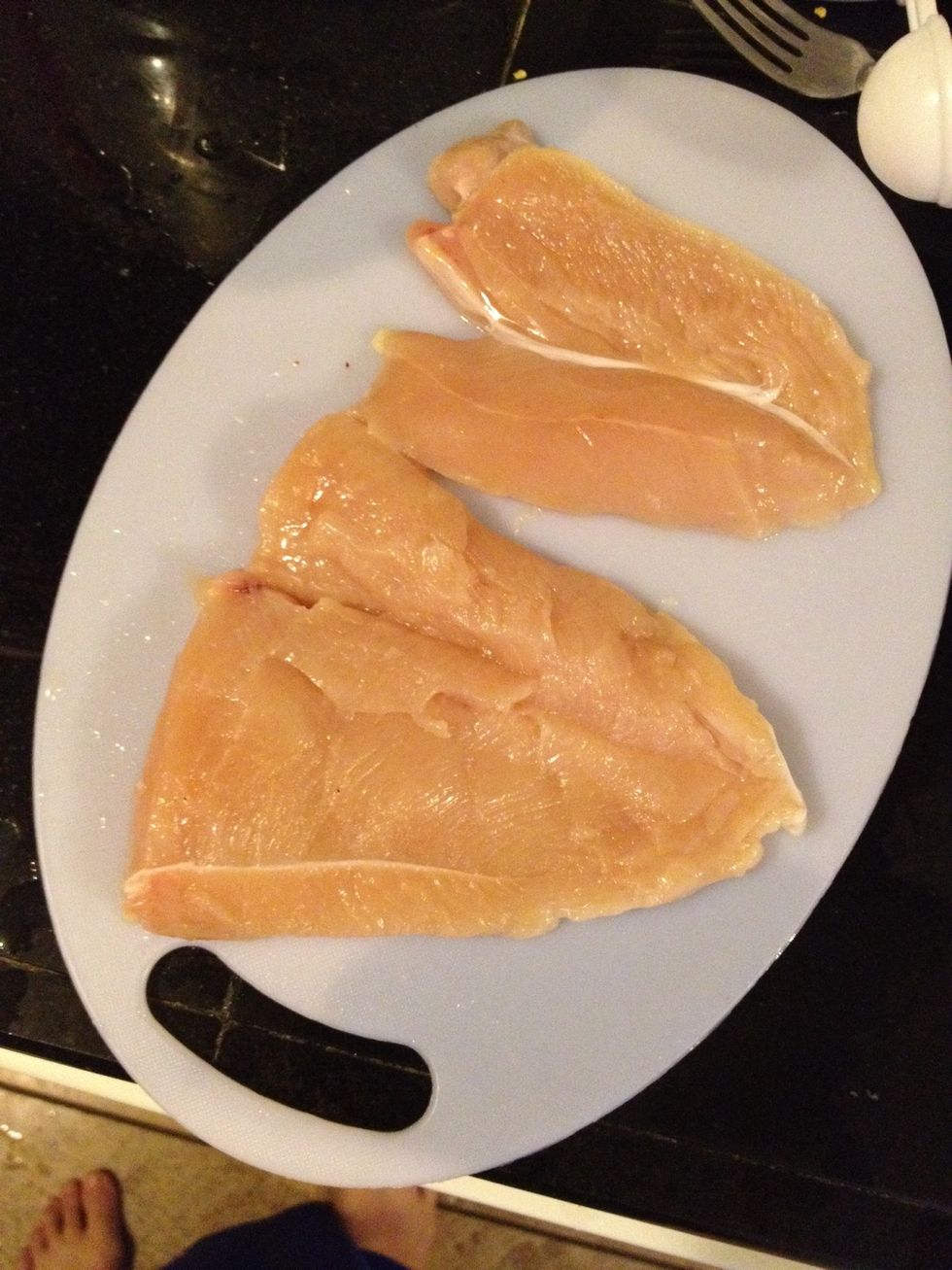 Cut chicken breasts in half and pound out thin.