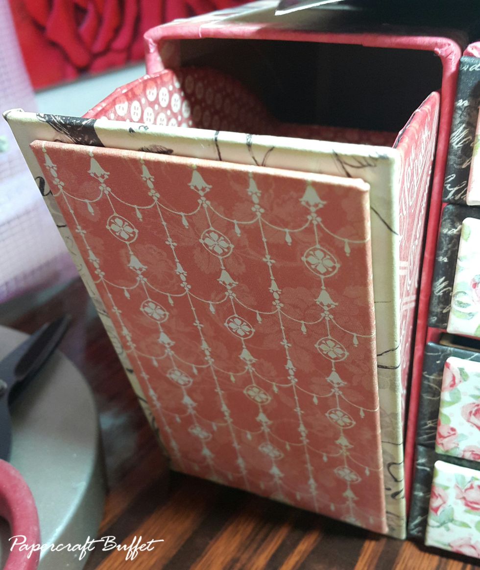 Cut chipboard 2-7/8"x5-1/8" and 2-1/2"x4-3/4", cover with paper, adhere on the front as door.