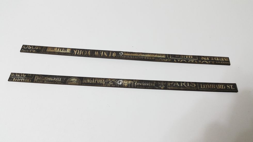 Cut chipboard 2pcs of 1/2"(W)x12"(L), cover with paper of the same size (front and back), ink the edges if desired. Punch holes in the middle.