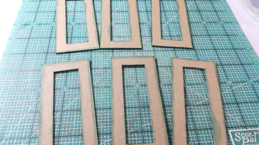 Cut chipboard 8pcs 2"x4-1/2", cut a window 1/2" from the edges, apply Distress Ink on edges.