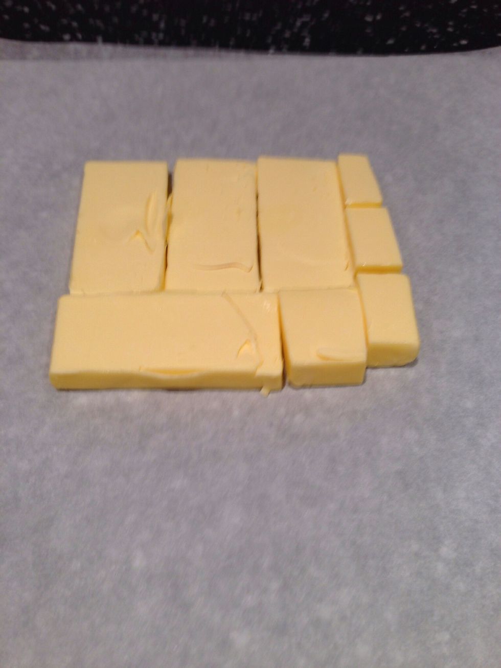 Cut cold butter from the refrigerator into 1.25cm slabs. Arrange on waxed paper to form a square of about 15x15cm. Cover with more waxed paper and pound with a rolling pin until it's 19x19cm
