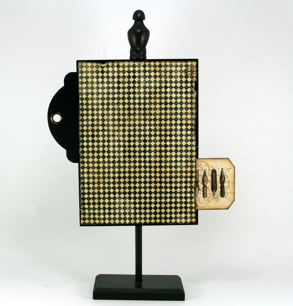 Cut Communique Society Page patterned paper 1/4 less than black cardstock. Distress and ink with Black Soot and adhere to stand.