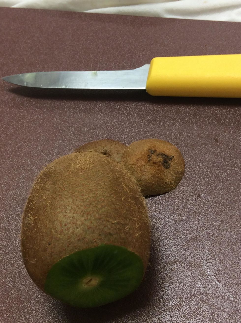 Cut each end of the kiwi off but not too much into the kiwi.