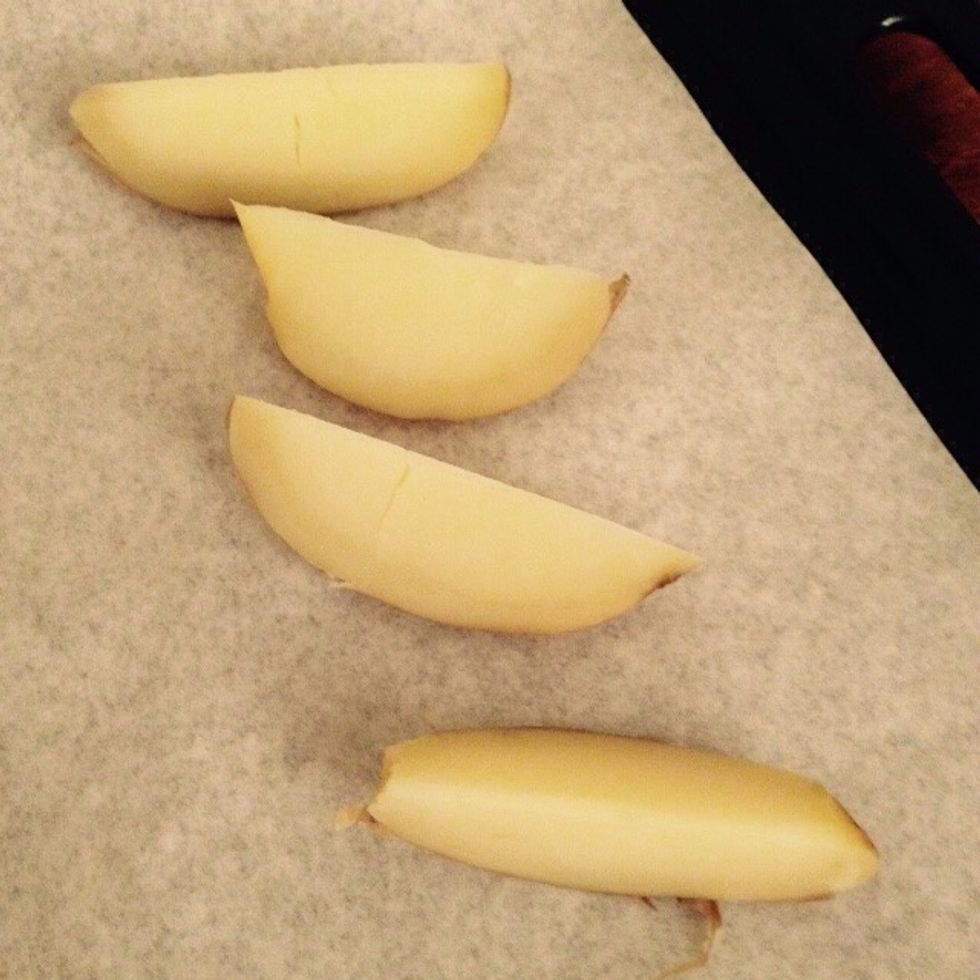 Cut each half into fourths lengthwise and place them on a baking tray with wax paper and some flour so that they won't stick