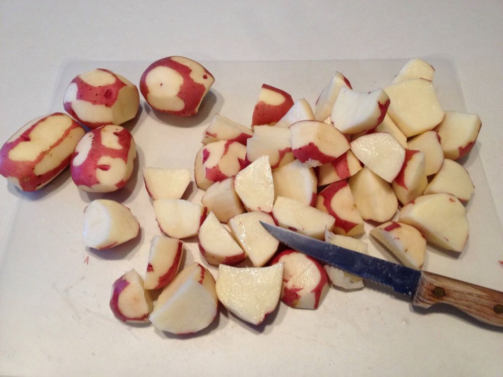 Cut each potato into quarters.