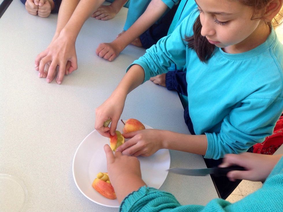 Cut each quarter of the apple in half and put some grapes or marshmellows inside.
