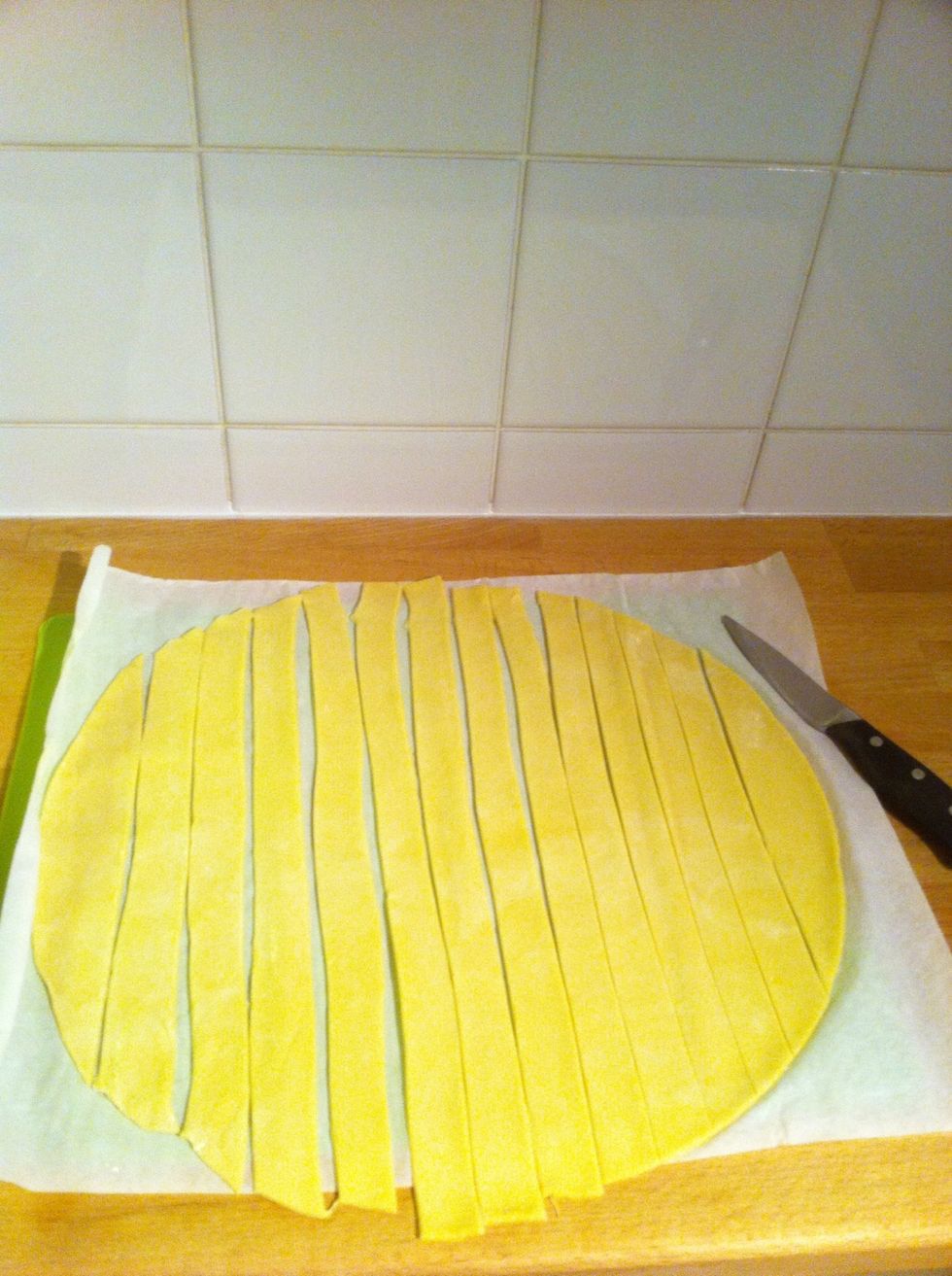 Cut each sheet of puff pastry into long strips, three times longer than the cheese strips