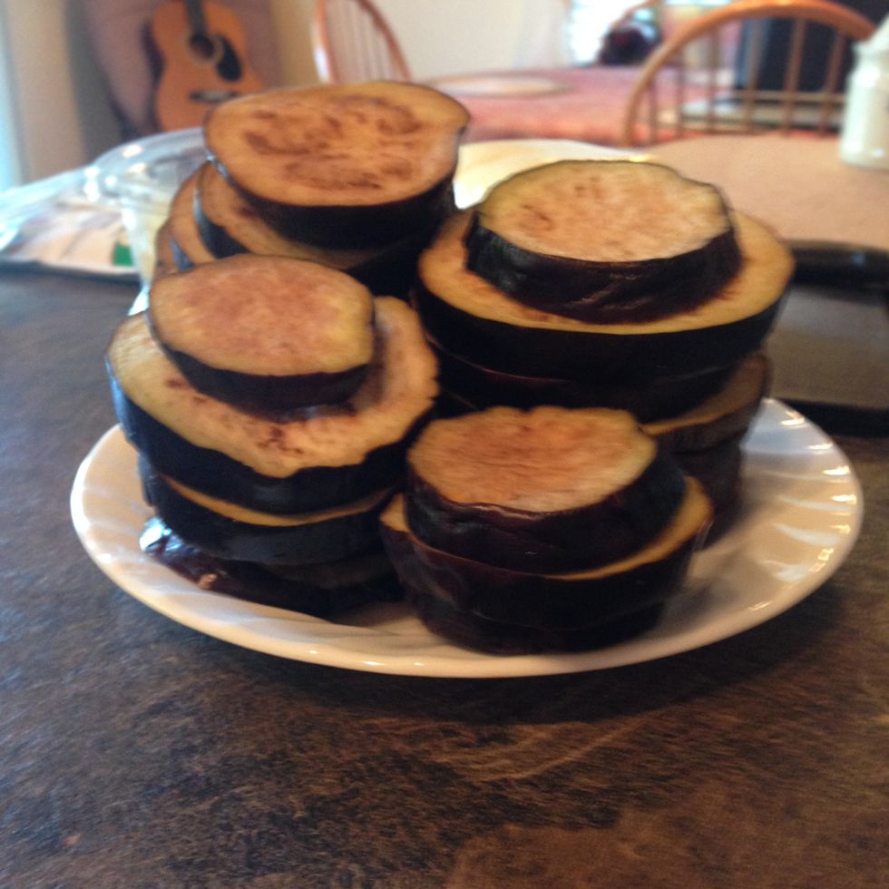 Cut eggplant into 1/4" slices. Line on baking sheet and salt both sides. Let sit about 1 hour to drain excess juices. Pat dry.