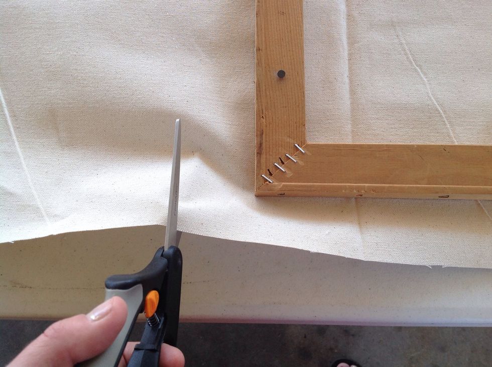 Cut excess canvas off the opposite two edges. Make sure not to cut too much!