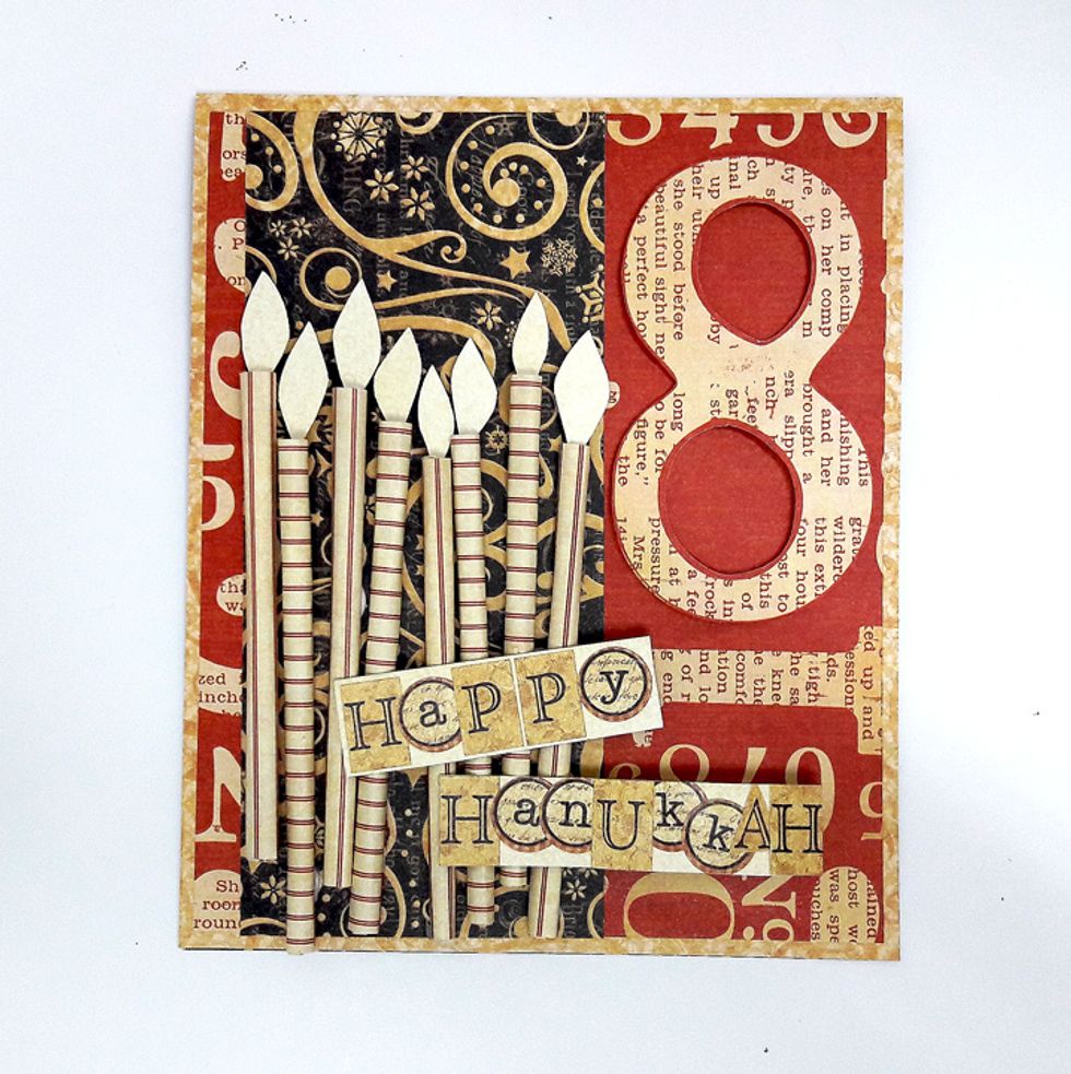 Cut flames from piece of scrap paper and attach to top of each candle with foam tape.